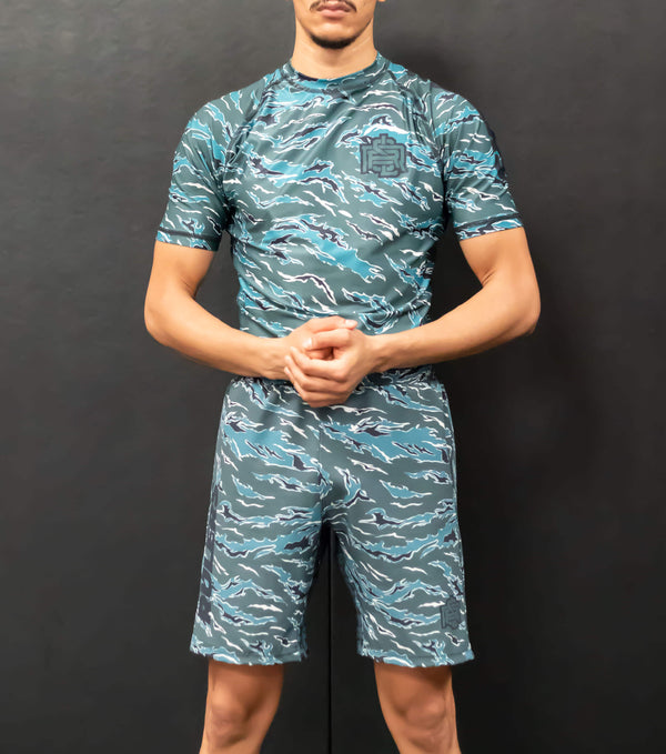 Athlete wearing RULERS Fight Shorts in camo pattern, showcasing strength and agility during an intense training session.