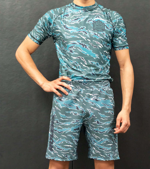 Athlete wearing RULERS Tiger Camo Green rashguard, showcasing the bold tiger camouflage design during a dynamic training session in a side view.